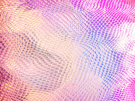 Holographic bright rainbow multicolor real crumpled texture background with an easy blur effect.の写真素材
