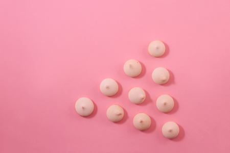 Zephyr cookies laid out with a vertical row on a light gentle pink background.の写真素材