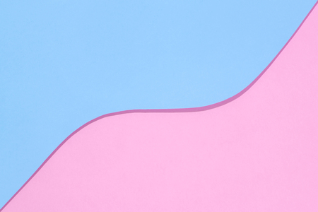 Abstract geometric bright double pastel color flat lay paper background consisting of 2 shades - light pink and light blue with a place for an inscription.の写真素材