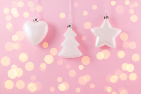 Pale pink composition on a New Year's theme. A small decorative Christmas balls for decoration on a pink background magical holiday lights.の写真素材