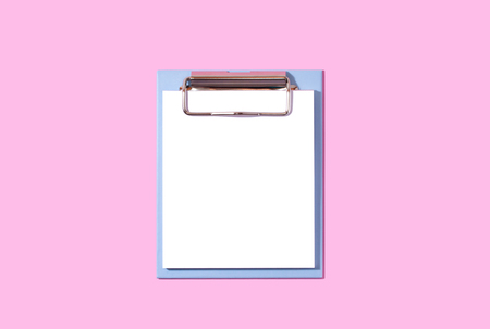 Blue note with white stickers on a pink paper background.の写真素材