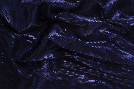 Large shiny glossy dark blue sequins fully filling the background space.の写真素材