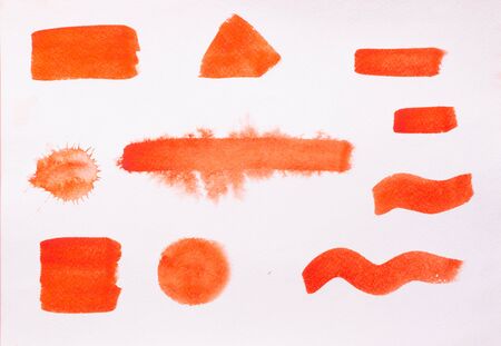 Trend photo on the theme of fashionable orange hue this season. Bright smear of watercolor paint on a white paper background.の写真素材
