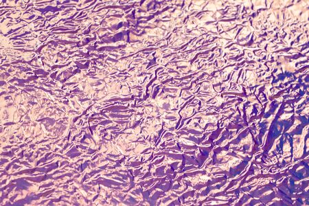 Blurred holographic bright rainbow multicolor real crumpled texture background. Side view. Close up.の写真素材