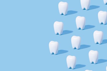White teeth pattern on a blue paper background with text place.の写真素材