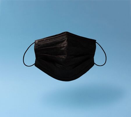 Creative composition on the theme of protective equipment from Covid-19. Levitating real black...