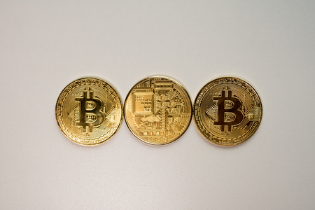 Face and back of the crypto currency golden bitcoin isolated on white background. The concept of virtual international currency and business on the Internet.の写真素材