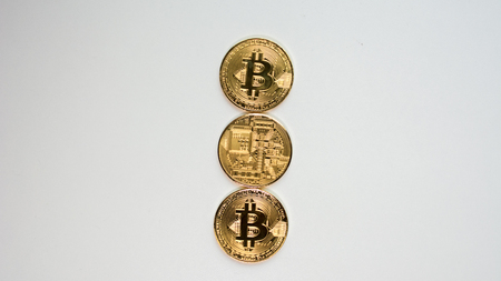 Face and back of the crypto currency golden bitcoin isolated on white background. The concept of virtual international currency and business on the Internet.の写真素材