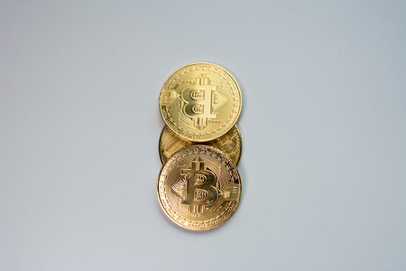 Face and back of the crypto currency golden bitcoin isolated on white background. The concept of virtual international currency and business on the Internet.の写真素材