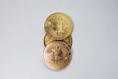 Face and back of the crypto currency golden bitcoin isolated on white background. The concept of virtual international currency and business on the Internet.の写真素材