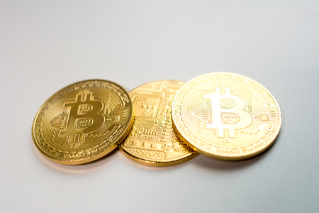Face and back of the crypto currency golden bitcoin isolated on white background. The concept of virtual international currency and business on the Internet.の写真素材