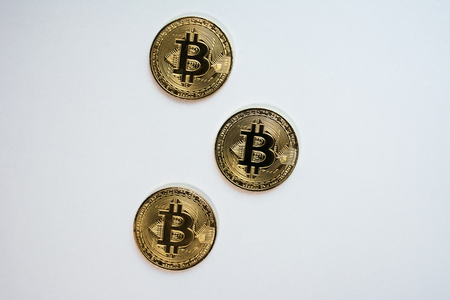 Face and back of the crypto currency golden bitcoin isolated on white background. The concept of virtual international currency and business on the Internet.の写真素材