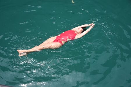 View from above as a girl swims in the open Adaman Seaの写真素材