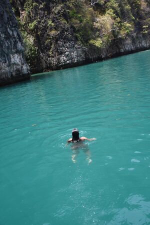 View from above as a girl swims in the open Adaman Seaの写真素材
