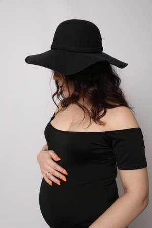 Beautiful young pregnant woman posing in Studioの写真素材