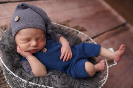 Sleeping newborn boy in the first days of life. Newborn photo session.の写真素材