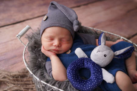 Sleeping newborn boy in the first days of life. Newborn photo session.の写真素材