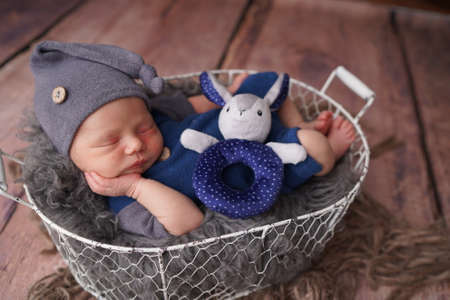 Sleeping newborn boy in the first days of life. Newborn photo session.の写真素材
