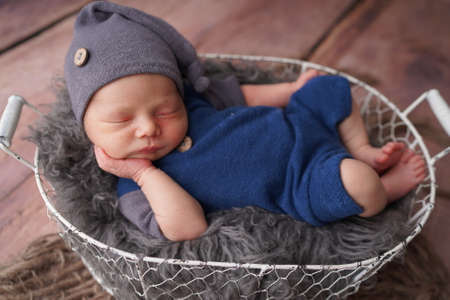 Sleeping newborn boy in the first days of life. Newborn photo session.の写真素材
