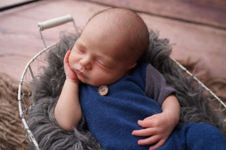 Sleeping newborn boy in the first days of life. Newborn photo session.の写真素材