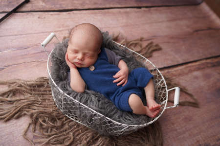 Sleeping newborn boy in the first days of life. Newborn photo session.の写真素材