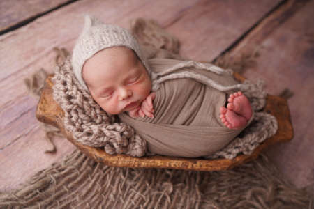 Sleeping newborn boy in the first days of life. Newborn photo session.の写真素材