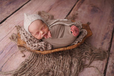 Sleeping newborn boy in the first days of life. Newborn photo session.の写真素材