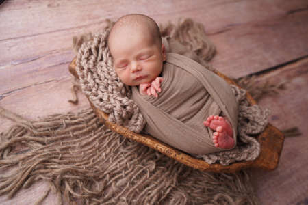 Sleeping newborn boy in the first days of life. Newborn photo session.の写真素材