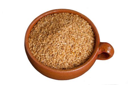 Ceramic bowl with brown flax seed in isolated on white の写真素材