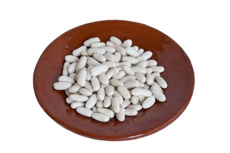 Raw white beans in small ceramic plateの写真素材