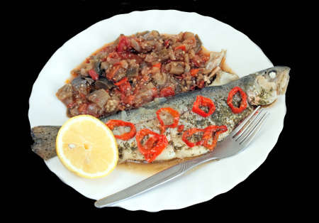 Baked fish with stuffed vegetables and lemon