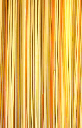 Color Spagetti with vegetables as backgroundの写真素材