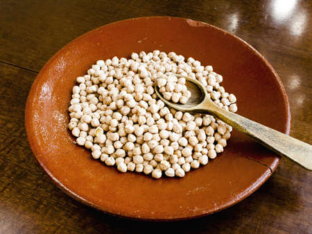 Chickpeas in old ceramic plate with wooden spoonのeditorial素材