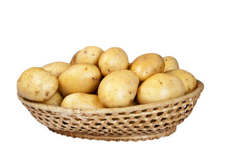 Potatoes in wicker basket isolated on white backgroundの写真素材