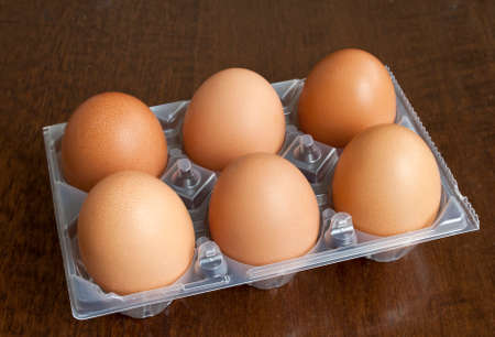 Half dozen fresh hen eggs in plastic boxの写真素材