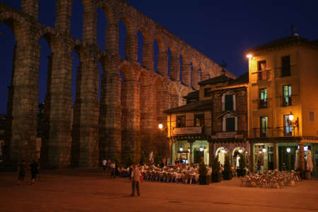 Segovia,Spain-July 24: Street cafe near roman aqueduct in the evening in Segovia, Spain-on July, 24, 2009のeditorial素材
