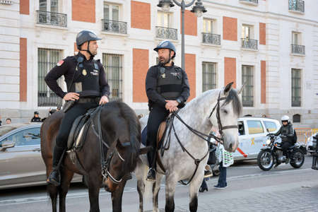 Madrid, Spain-24 February 2019: Police on horses are watching and helping people squareのeditorial素材