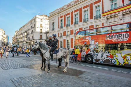 Madrid, Spain-24 February 2019: Police on horses are watching and helping people en the squareのeditorial素材