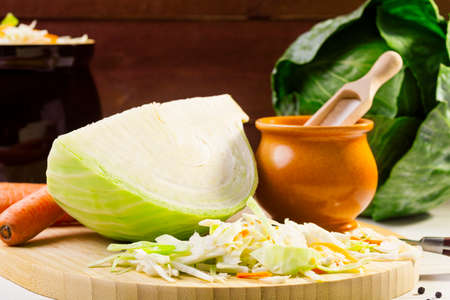 Fresh cabbage prepared for pickling on woodboardの写真素材