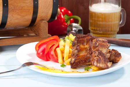 Grilled ribs on plate, served with friesの写真素材