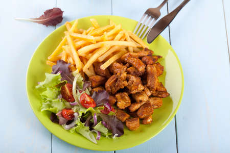 shaorma chicken on a plate with fries and saladの写真素材