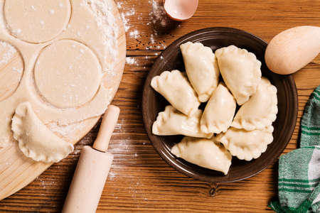 Preparing homemade dumplings - wooden backgroundの写真素材