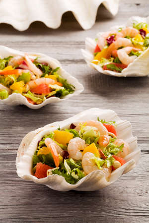 Shrimp salad with grapefruit, orange and roasted peanuts. - Served in sea shells