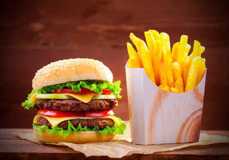 Hamburger with fries on wood boardの写真素材