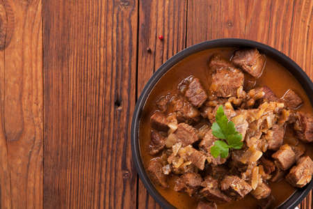 Preparing beef stew - wooden backgroundの写真素材