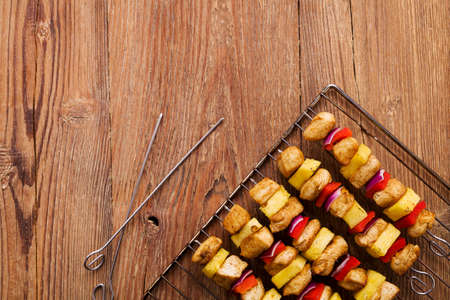 Grilled chicken skewers with pineapple, peppers and onionsの写真素材