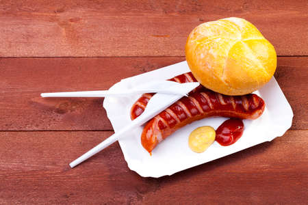 Roasted sausage with bread served on a paper trayの写真素材
