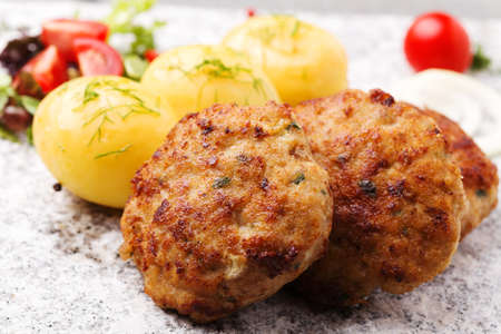 Fresh, homemade meatballs, served with tomato salad and new potatoes.の写真素材