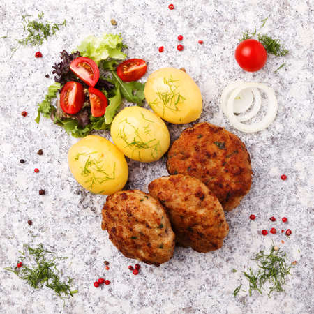 Fresh, homemade meatballs, served with tomato salad and new potatoes.の写真素材