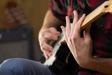 Young man playing electric guitar.の写真素材